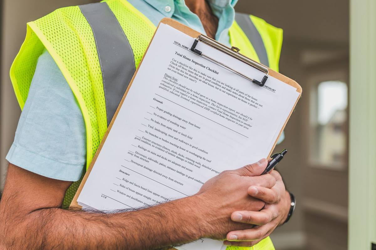 Inspector holding a checklist on a clipboard